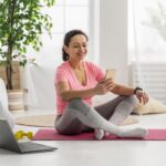 full shot woman holding smartphone